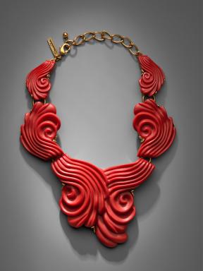 A bright-red swirly coral resin necklace. 