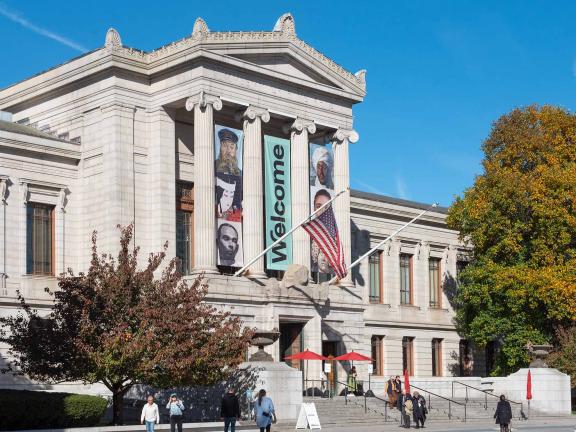 Façade of the Museum's Huntington Avenue Entrance with three "Welcome" banners above the entrance greeting visitors