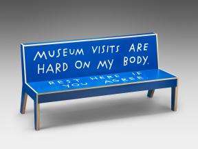 A blue bench written on with "Museum visits are hard on my body. Rest here if you agree."