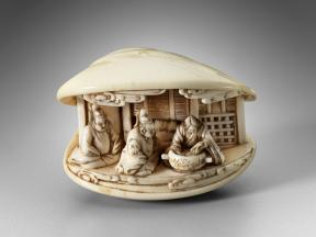 A clam shell carved from ivory houses three inhabitants between the individual shells.