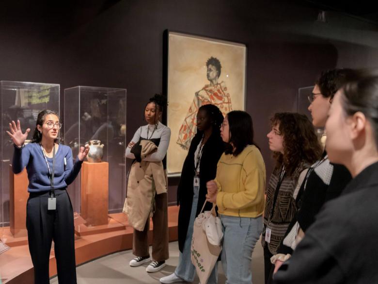 An MFA exhibition designer shows a cohort of interns around Hear Me Now