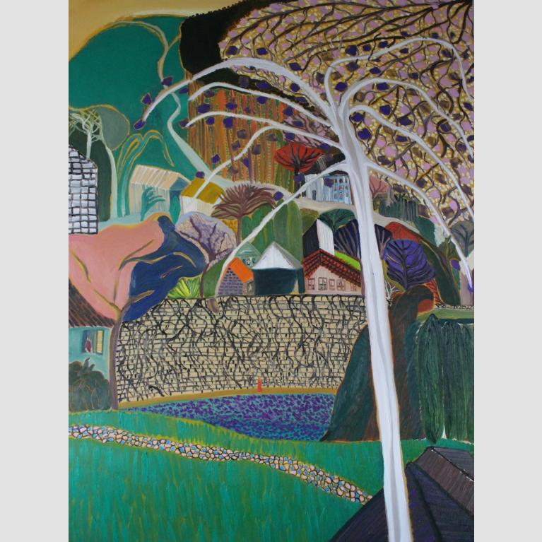 A small town on a hill with a bare, white tree in the foreground