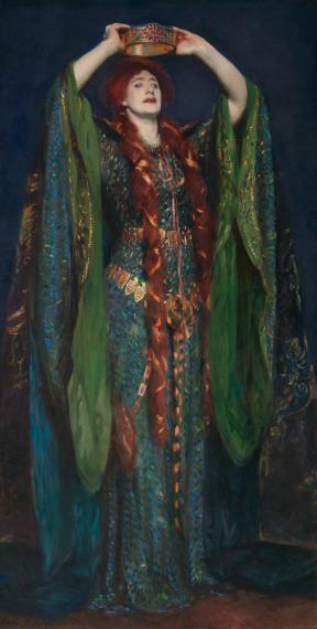 Actress Ellen Terry dressed in a green gown as Lady Macbeth holds a crown over her head. 