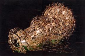 Embroidered gold and yellow beads on a black background depict a chandelier. 