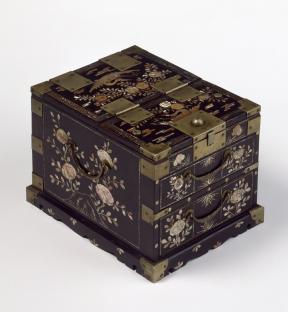 A dark brown lacquered wooden box with mother-of-pearl inlay and brass fittings.
