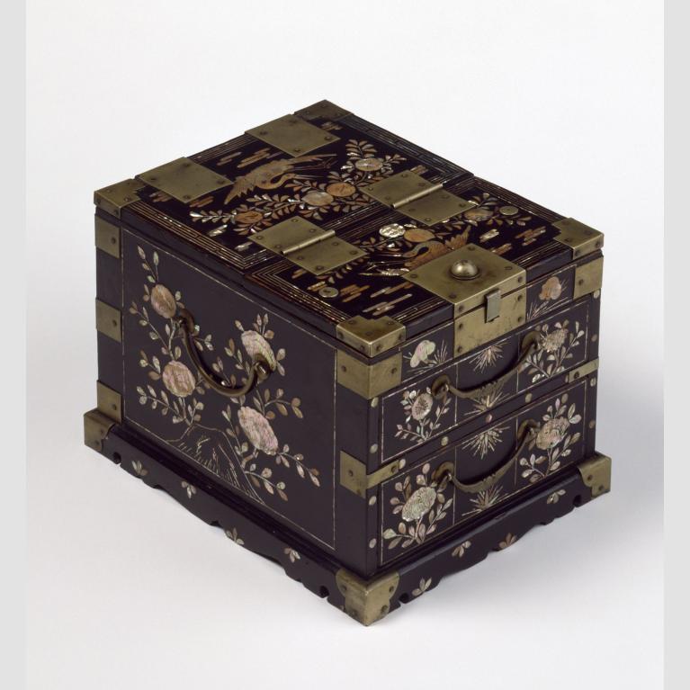 A dark brown lacquered wooden box with mother-of-pearl inlay and brass fittings.