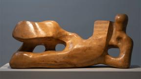 Wooden sculpture that abstractly resembles a reclining figure