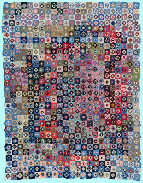 A quilt composed of multicolored squares, each with two contrasting circle inside of it.