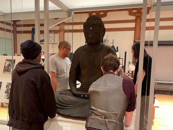 Installation of Amida sculpture into a case in the public Conservation in Action studio