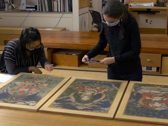 Conservator and curator examine Tara paintings