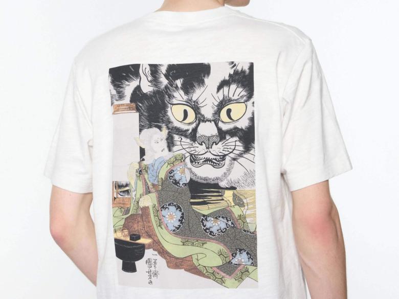 Back view of model wearing UNIQLO's "Dark Fantasy" t-shirt, featuring ukiyo-e print depicting surprised person looking back at giant cat