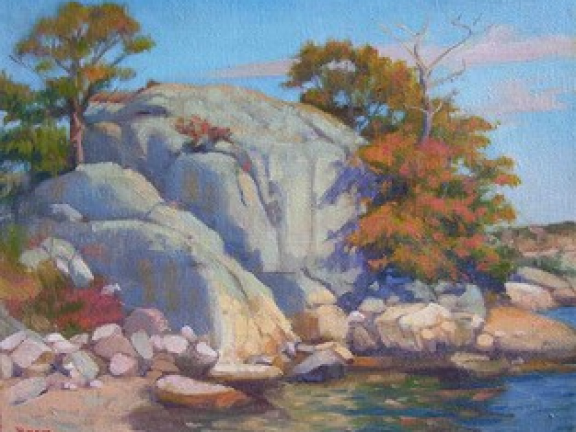 Instructor painting of rocks and trees for studio art class